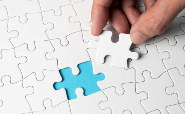 hand placing puzzle piece